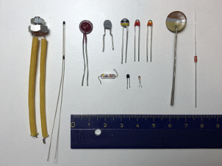 A few different models of NTC: some are color-coded with the R25 value, some are extremely small to minimize thermal mass and some others are designed to be easily mounted on a heat sink. (click to enlarge)
