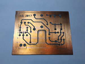 Not all toner transferred well, so I had to re-touch some areas with a permanent marker. Now the PCB is ready for etching. (click to enlarge)